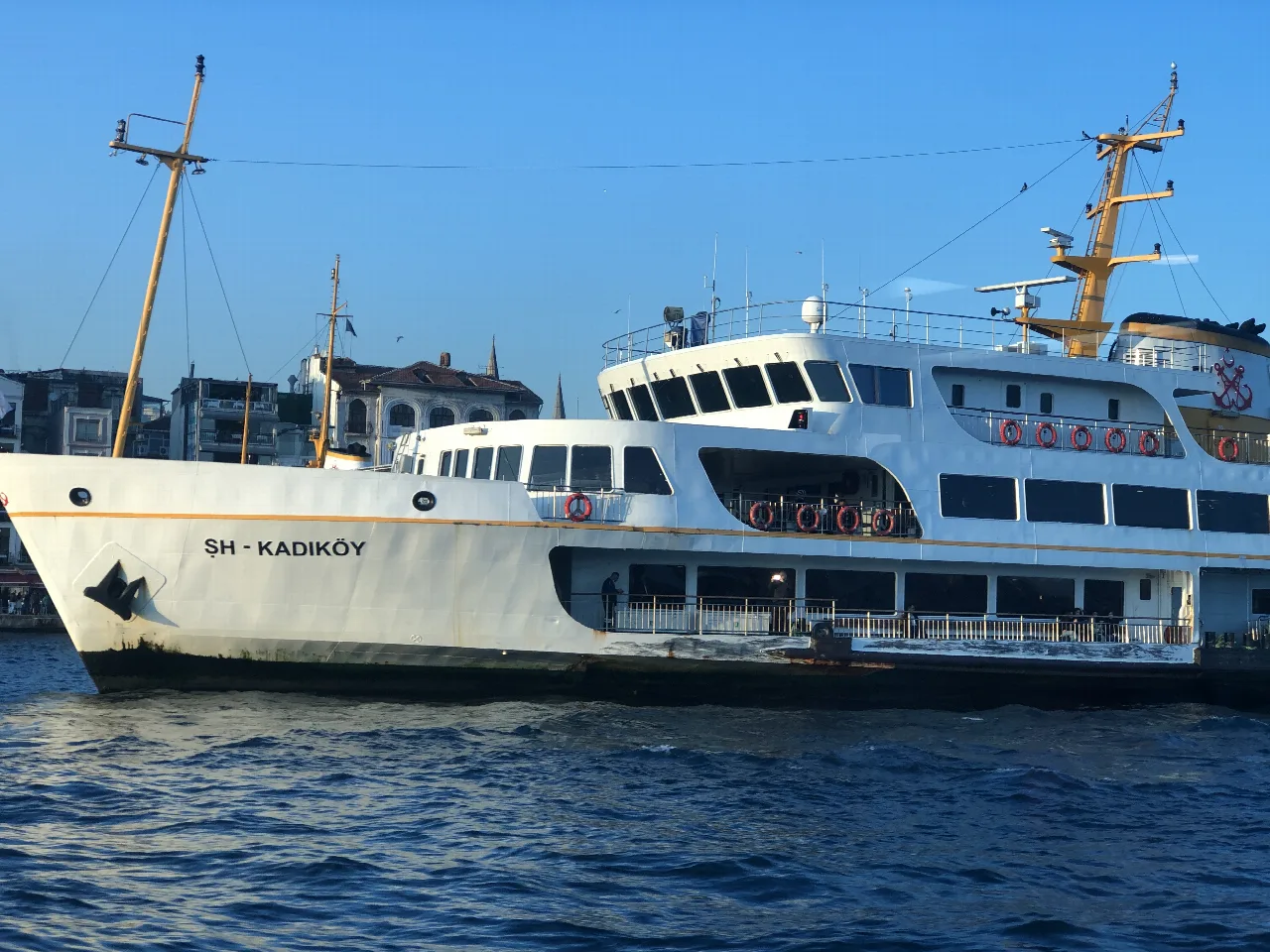 Ferry blanco de Şehir Hatları navegando junto a la orilla de Estambul.