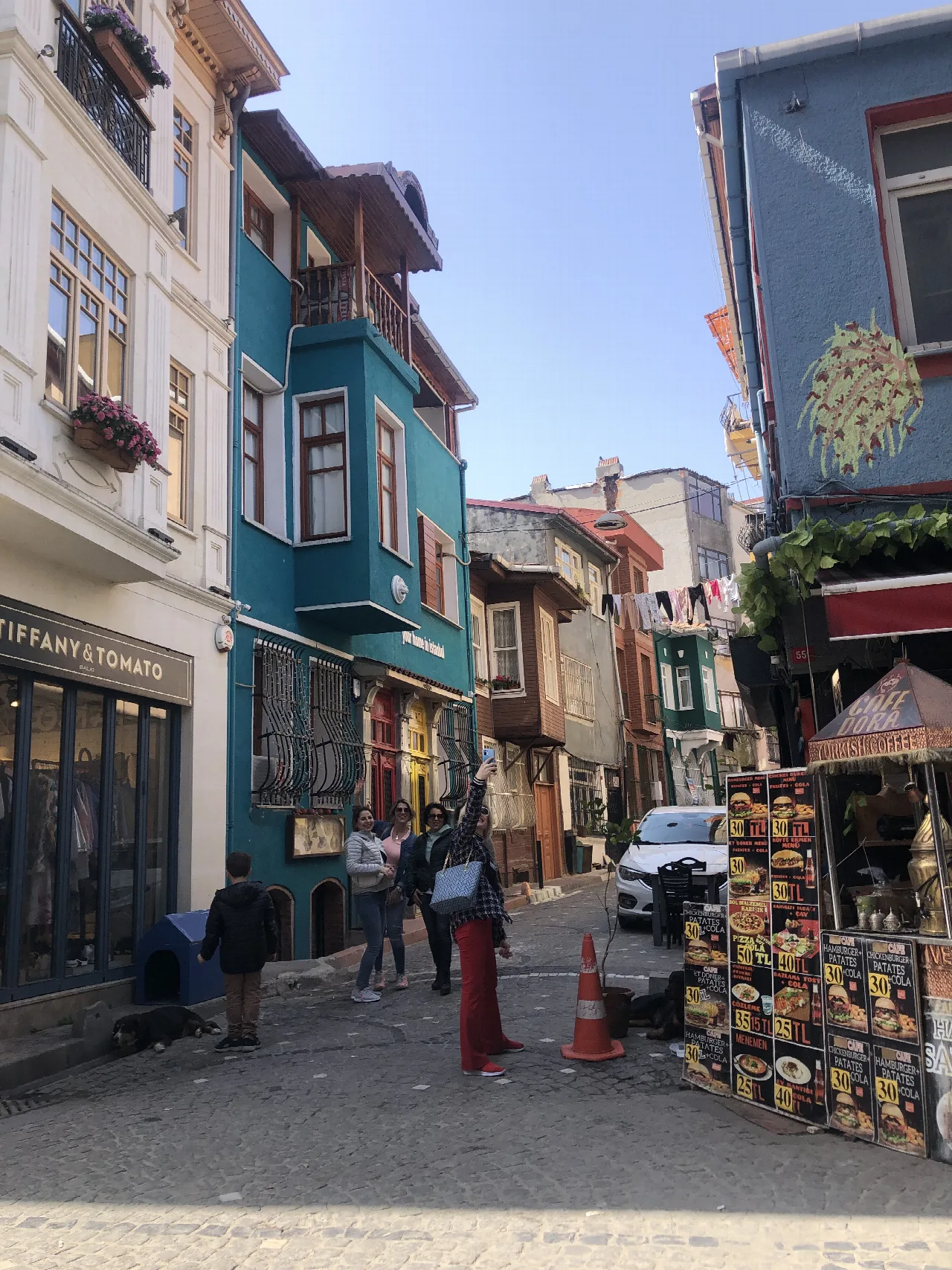 Calle de Balat con fachadas de colores y terrazas de cafeterías.