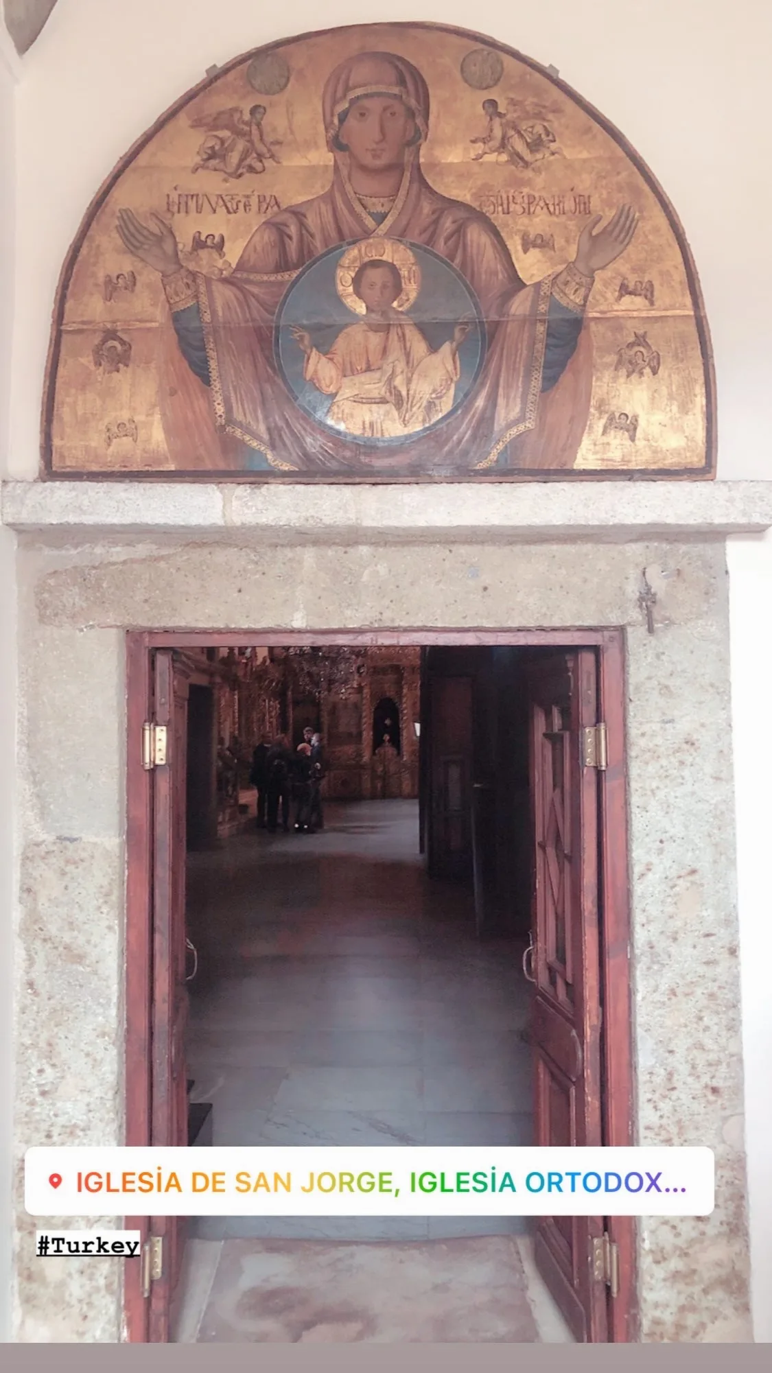Entrada de la iglesia de San Jorge en Fener con una imagen religiosa sobre la puerta.